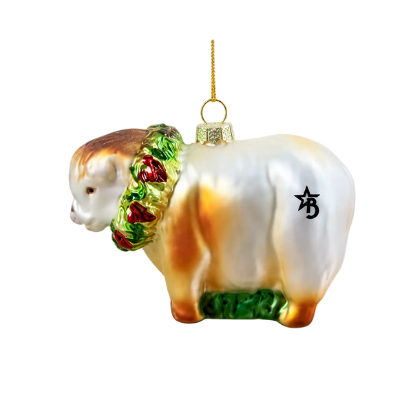 Glass ornament of a sheep with a wreath on a white background