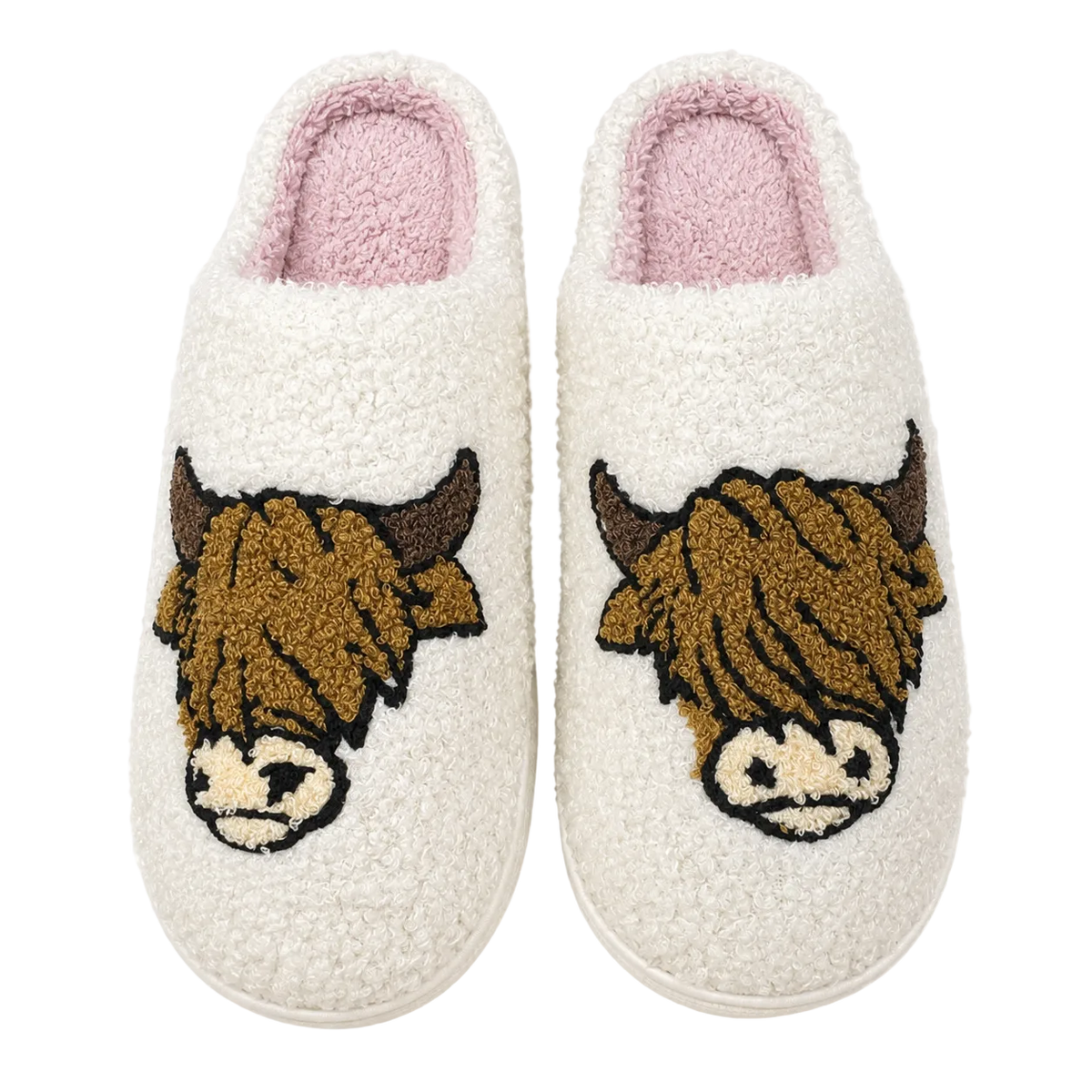 Pair of white slippers with highland cow designs on a white background