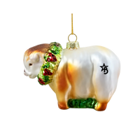 Glass ornament of a sheep with a wreath on a white background